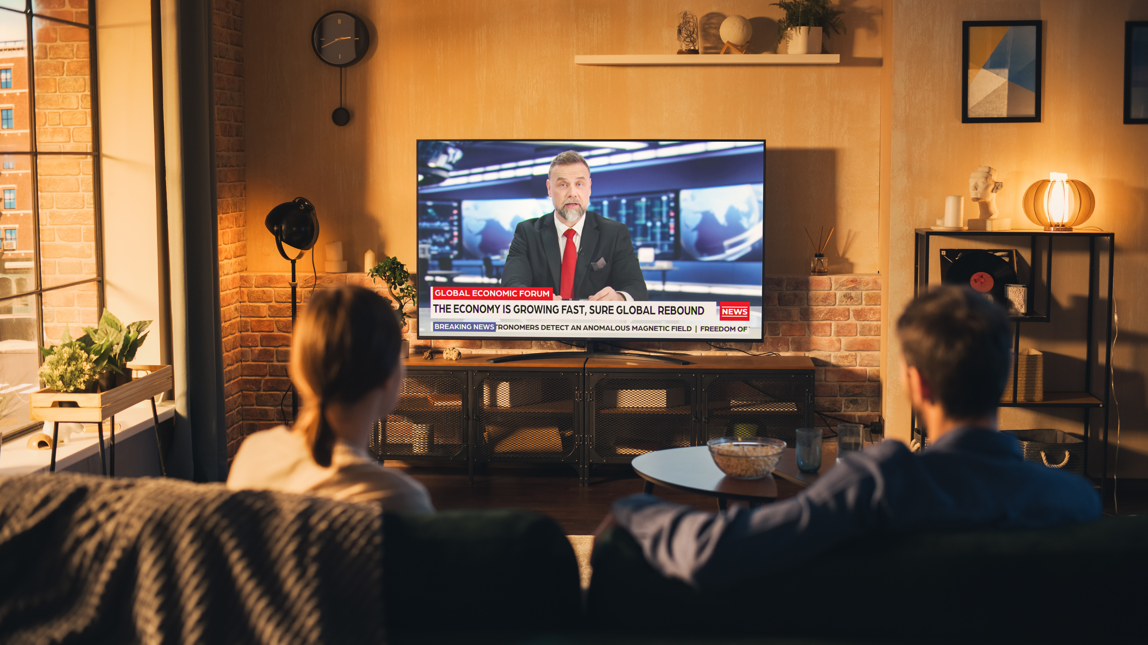 couple-watches-news-broadcast.jpg