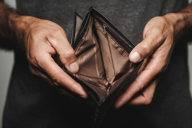 man-holds-open-empty-wallet.jpg