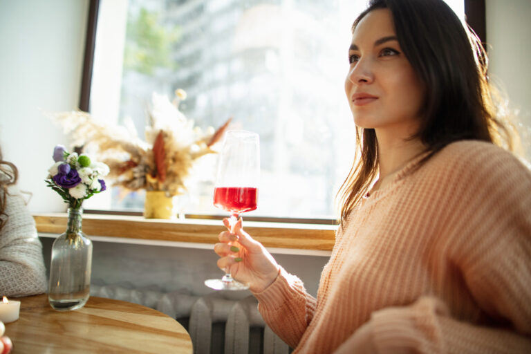 young-woman-holds-drink-hands.jpg